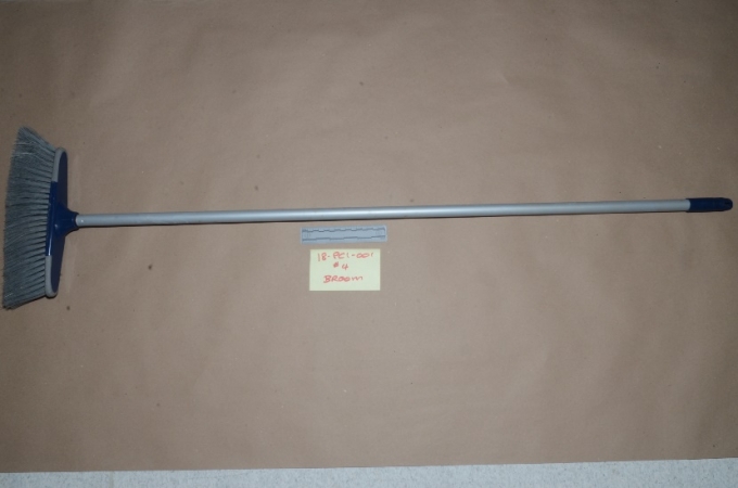 The broom wielded by the Complainant.