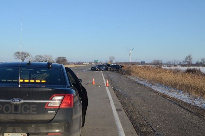 Approaching collision scene, showing VW in contact with rear of police vehicle.
