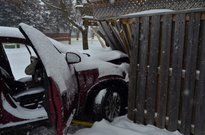 Close up of the SUV after colliding with the fence.