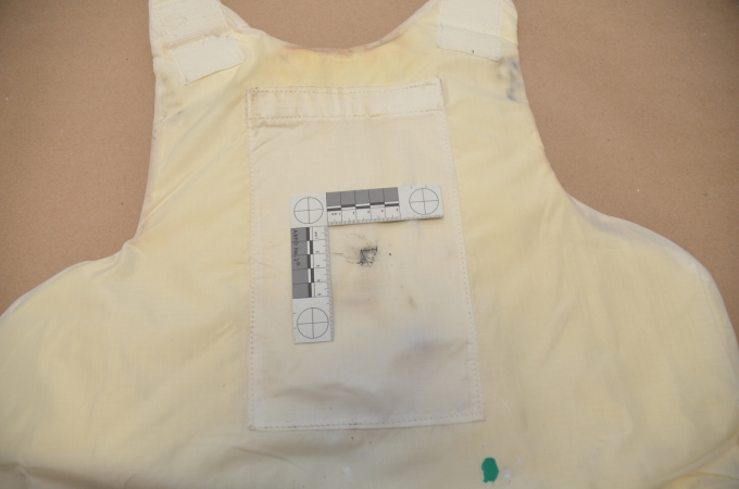 The interior of SO #1's ballistic vest showing the impact of a bullet.