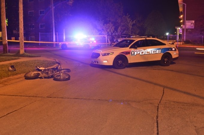 The crashed motorcycle and the police vehicle involved in the pursuit.