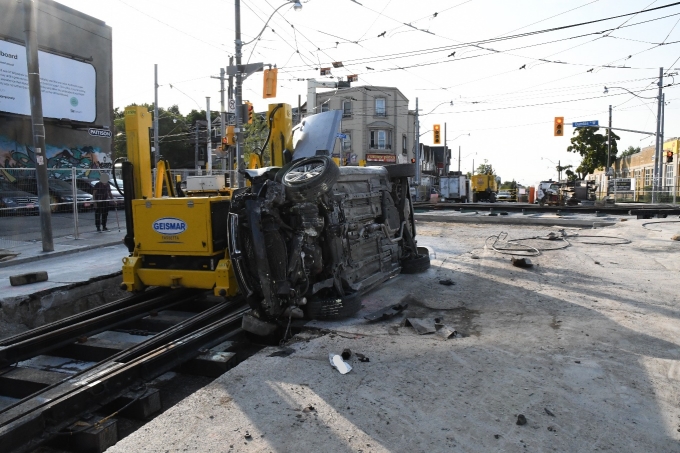 The Dodge Avenger resting on its right side following the collision.