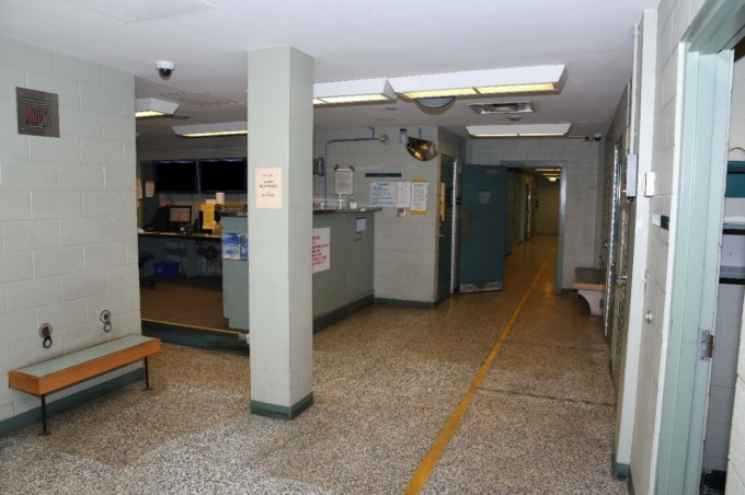 Figure 1 - The booking area at the police station. The open green door leads to a search room.