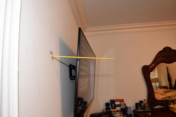 Figure 8 - A rod placed through the bullet strike to the master bedroom's wall to demonstrate its trajectory.