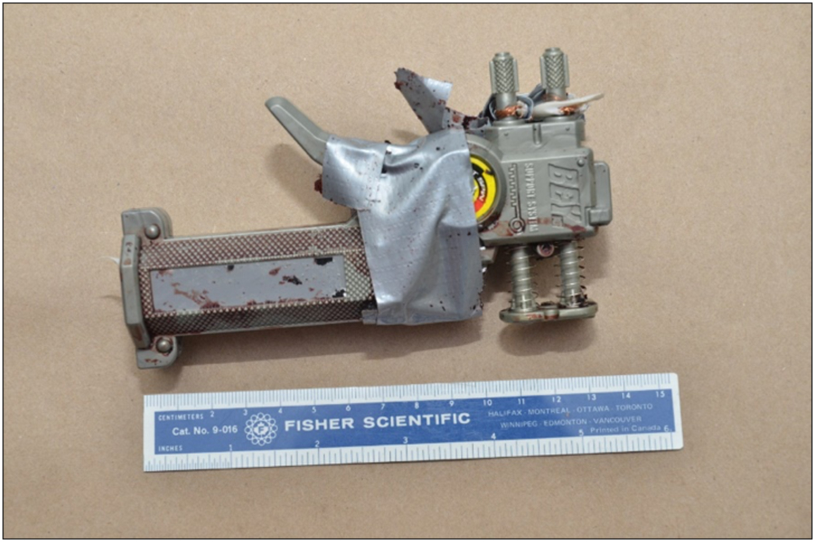 one Beyblade ® palm-held toy-launcher reconfigured to appear as a ‘dead-man’ switch bomb detonator